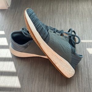 Navy blue New Balance kids tennis shoe.